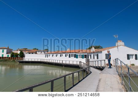 Ile de RÃ© Man and dog in village Loix in the harbor