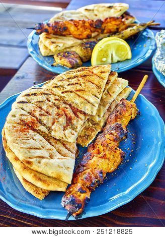 Spiced Chicken Souvlakis With Seasoned Pita Bread. Typical Greek Skewer.