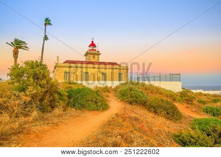 Scenic Lagos Lighthouse Or Farol Ponta Da Piedade Atop The Spectacular Cliffs Of Ponta Da Piedade At