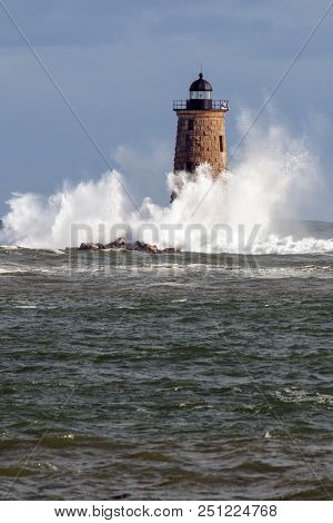 Rare High Tide Causes Giant Waves To Break Around The Stone Tower Of Whaleback Lighthouse In Maine.