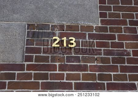 Index With The Number 213 On The Facade Of A Brick House