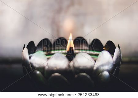A Row Of Oil Lamp Lighting In Thai Temple