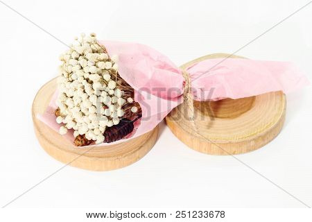 Closeup Of Bouquet Dried White Eriocaulon Henryanum Ruhle On Round Teak Wood.