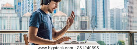 Young Man Teaches A Foreign Language Or Learns A Foreign Language On The Internet On Her Balcony Aga