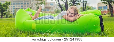Young Woman Resting On An Air Sofa In The Park.. Lamzac Banner, Long Format