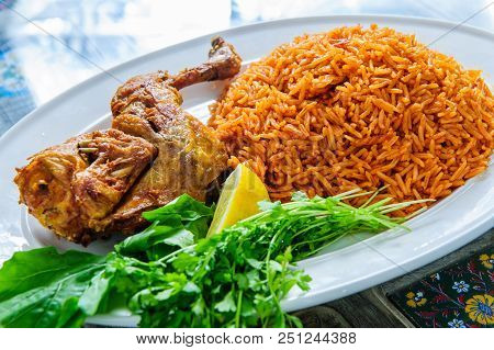 Plate Of Rice With Duck Leg And Greens.