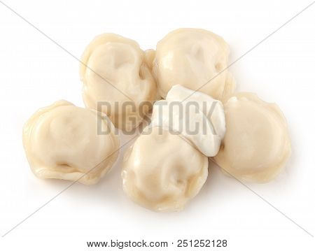 Handful Of Boiled Dumplings With Sourcream On The White