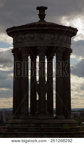 Silhouette Of Calton Hill Monumner With A Cloudy Evening  Sky In The Background