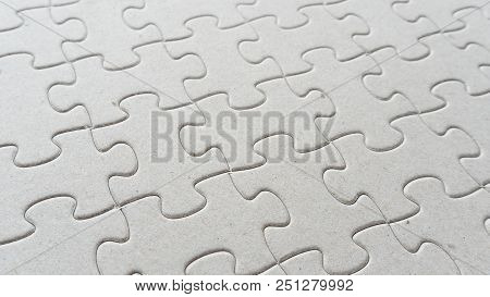 Hand Put Missing Jigsaw Puzzle Into The Paper Board