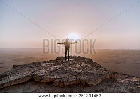 Alone Man In Israel Negev Desert Admires The View Of Sunrise. Young Male Person Stands On The Edge O