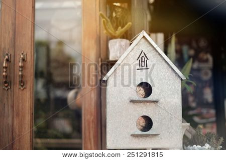 Small Home Made Of Zinc Placed On Front Of Real House Have Ornamental Plants And Door Background