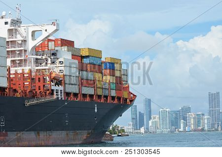 Containership Approaching The Port Of Miami,miami,florida With A Full Load Of Cargo.downtown Miami S