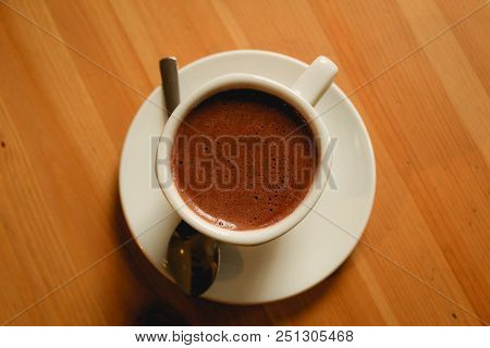 Hot Chocolate At White Cup Over Wooden Table
