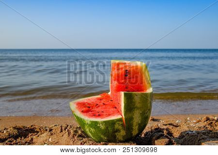 The Cut Watermelon Lies On The Seashore. Watermelon In The Sea.