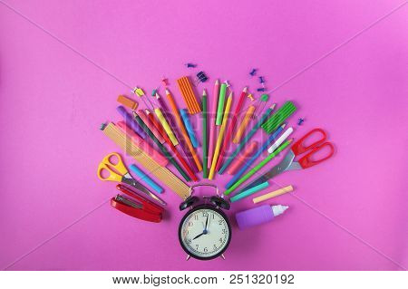 Back To School Accessories For School On A Purplebackground Pencils Plasticine Alarm Clock Briefcase