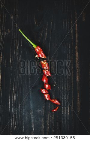 Red Hot Chilli Pepper On Black Wood, Top View