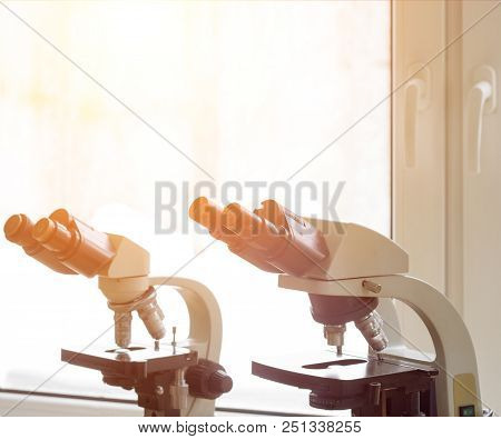 Two Microscopes For Examination Stand In The Laboratory On The Table, The Sun, Glass