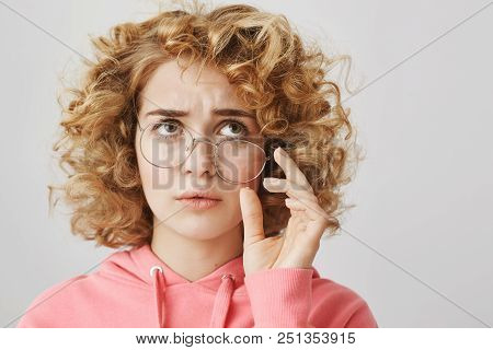 Confused And Troubled Woman Tries To Recall What Happened. Portrait Of Worried And Questioned Curly-