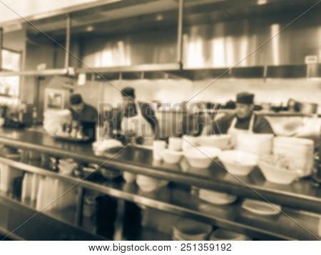 Vintage Blurred Background Chef Preparing For Lunch Service In Asian Restaurant Kitchen