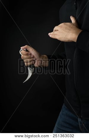 Crime And Violence Concept, A Murderer With A Karambit Knife Trying To Kill Victim