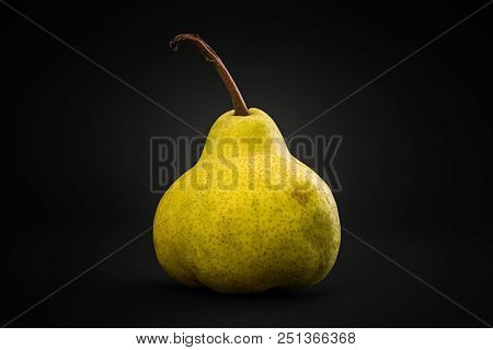 Yellow Pear On A Black Background. Close-up