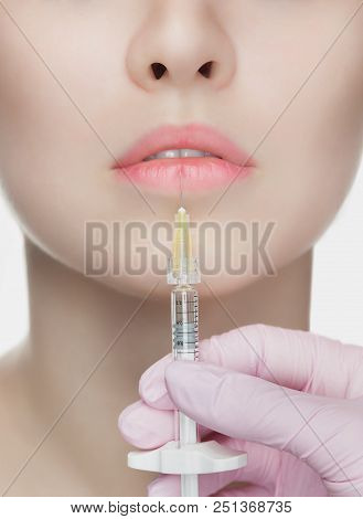 The Cosmetologist Makes Injections Of Botulinum Toxin In The Lips Of The Patient. Cosmetology Skin C