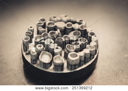 Object Printed On Metal 3d Printer Isolated. Dental Crowns Created In A Laser Sintering Machine Clos