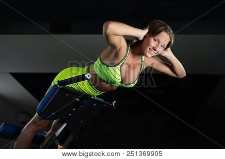 Sports Young Woman Doing Exercises On Trainer Back Machine In The Gym, Doing Hyperextension