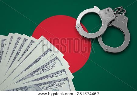 Bangladesh Flag  With Handcuffs And A Bundle Of Dollars. The Concept Of Illegal Banking Operations I