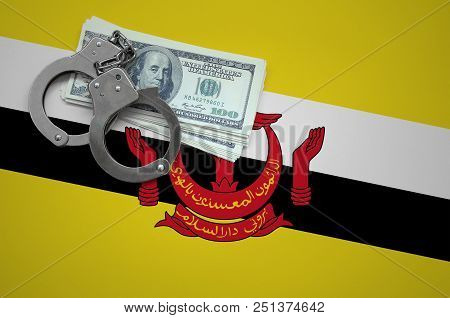 Brunei Darussalam Flag  With Handcuffs And A Bundle Of Dollars. The Concept Of Breaking The Law And 