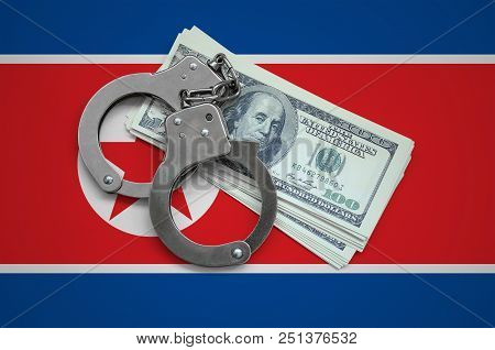 North Korea Flag  With Handcuffs And A Bundle Of Dollars. Currency Corruption In The Country. Financ