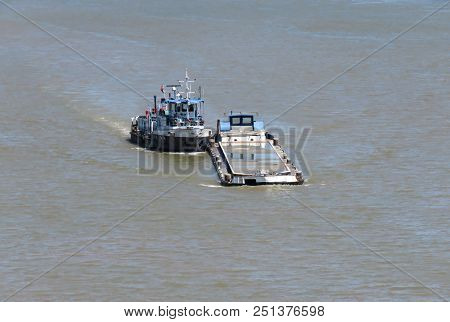 Thug Boat Maneuvers Cargo Ship On The Sava River, Belgrade, Serbia.