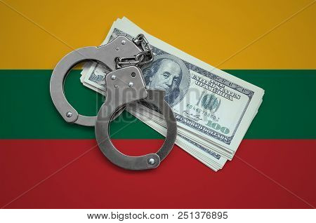 Lithuania Flag  With Handcuffs And A Bundle Of Dollars. Currency Corruption In The Country. Financia