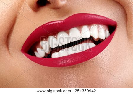 Close-up Happy Smile With Healthy White Teeth, Bright Red Lips Make-up. Cosmetology, Dentistry And B