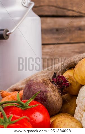 White Milkcan And Vegetables. Beetroot, Tomatoes, And Potatoes. Cropped Vertical Image.