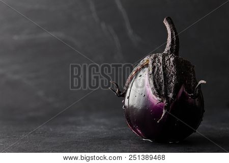Fresh Italian Type Eggplant Or Aubergine With Water Drops Closeup On Black Background