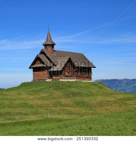 Old Timber Chapel On A Hill Top In Stoos, Switzerland.