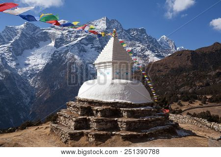 Buddhist White Stupa With Prayer Flags Above Namche Bazaar On The Way To Everest Base Camp, Sagarmat