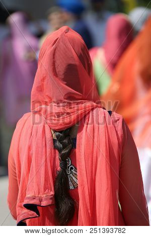 Sikh Woman With Long Black Hair And Red Dress During The Cerimony