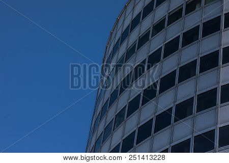Modern Glass Skycrapers Background With Sky And Clouds Reflection