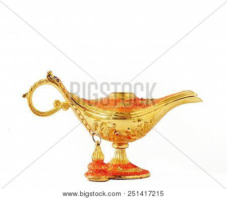 Ginie Wish Lamp Gold And Red In Color With A White Background