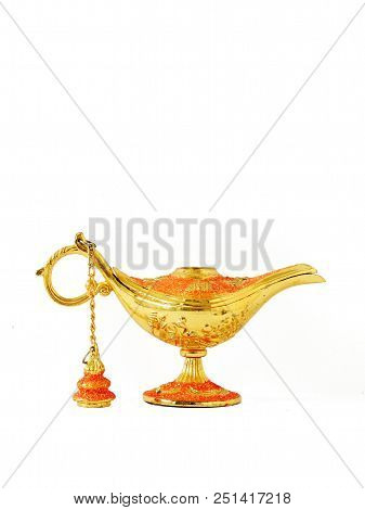 Ginie Wish Lamp Gold And Red In Color With A White Background