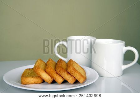 Rusk Or Toast With Coffee Mugs In Background