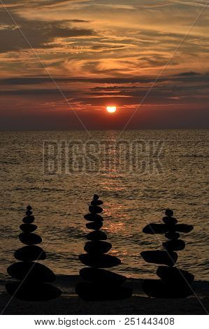 Relax Zen Stones Balanced. Black Pebbles At Sunris