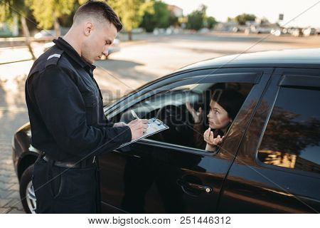 Male police officers check vehicle on the road