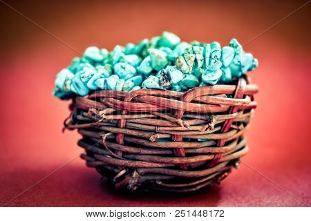 Pile Stones Of Raw Turquoise In Small Wooden Nest On A Wine Red Background. Blue And Green Color Sto