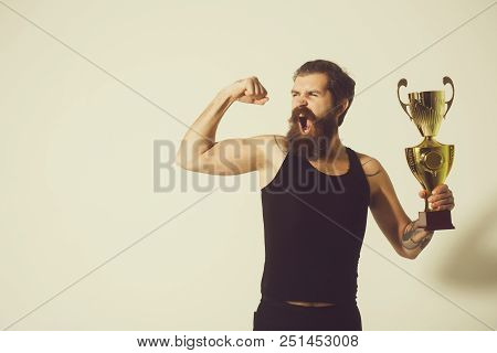 Bearded Man, Long Beard, Brutal Caucasian Hipster With Moustache In Black Vest Holds Gold Champion C