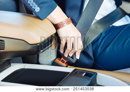 Safe Driving. Close Up Of A Seatbelt Being Fastened By A Professional Female Driver