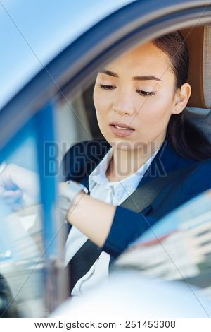 Heavy Traffic. Pleasant Young Woman Sitting In The Car While Being Late For Work