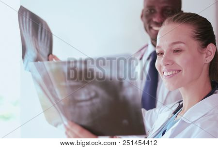 Doctors analyzing an x-ray in a meting. Doctors